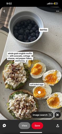 a plate with eggs and blueberries on it