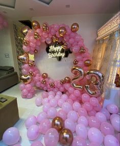 pink and gold balloons in the shape of numbers