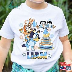 a little boy wearing a birthday shirt with his name on it and an image of a cartoon character holding a cake