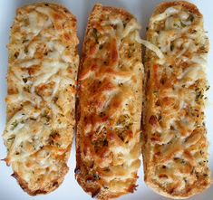 three cheesy bread sticks on a white plate