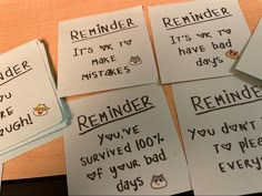 four reminders with words on them sitting on a table