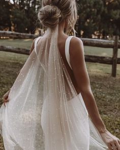 the back of a woman wearing a wedding veil