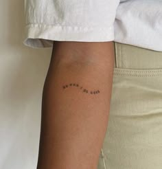 a woman's arm with the word love written in cursive writing on it