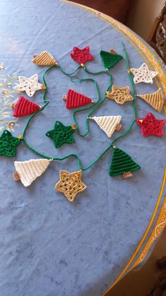 christmas decorations are arranged on the table for an ornament to be hung on