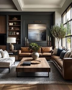 a living room filled with furniture and large windows