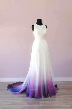 a dress on a mannequin in front of a purple and blue background with white trim