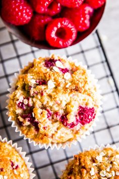 muffins with strawberries and oatmeal are on a cooling rack