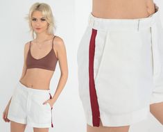 Vintage 80s tennis shorts by in white with a red stripe on the sides. Please see measurements and condition below. Every garment we sell is authentic vintage! You will receive the exact item photographed. Condition: Very good vintage. Best fits women's: Labelled size 30 Tag: Court Casuals Material:  Polyester MEASUREMENTS Taken from seam to seam while the garment is lying flat. Double the armpit, waist, and hips For reference, model is 5'7" and measures 31-23-35. Waist: 14.5" Hips: 19.5" Inseam: Summer Shorts With Side Stripes, Summer Bottoms With Side Stripes, White Short Bottoms With Side Stripes, White Bottoms With Side Stripes, White Shorts With Side Stripes, White Bottoms With Side Stripes For Summer, Retro White Fitted Shorts, White Shorts With Contrast Stripes For Summer, Space Age Dress