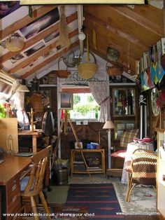 a room filled with lots of clutter and wooden furniture next to an open window