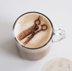 a cappuccino with chocolate sprinkles in it on a white table