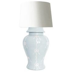 a white table lamp with a light blue vase on the base and a white shade