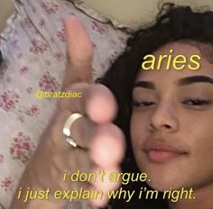 a woman laying in bed with her hand up to her face and the words aries above her