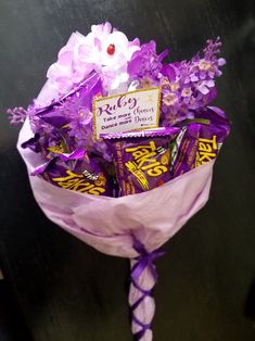 a bouquet of candy wrapped in purple paper