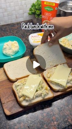 someone is making sandwiches with cheese on them