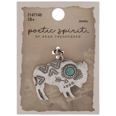 an elephant charm with turquoise stone in the center on a white carded tag for sale