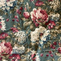 a blue floral fabric with red, white and pink flowers on the bottom half of it