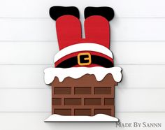 a christmas decoration made to look like a chimney with santa's hat on top