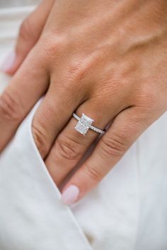 a woman's hand with a diamond ring on it