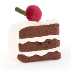 a piece of cake with white frosting and a cherry sitting on top of it