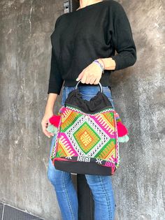 The beautiful Embroidered bag is made with an amazing piece of fabric woven by the Hmong hill tribes of Thailand. It's quite roomy inside the bag. There are 2 zippers at the front and the back too. So it is so roomy to put many things in there. The handle is Plastic handle but strong. There are 2 cute tassels on both side. It's embroidered by Hmong Hill tribe. The body of the bag is Hemp fabric which is strong and give you an antique look. Each bag will have only one because it is handmade.  Please note that we use Antique cloth so there might be an old look on the cloth.  Size : Width 29 cm, Height 32 cm. Depth 12 cm Handle : 13 cm Hemp Bag, Handmade Tote Bag, Unique Tote Bag, Hemp Fabric, Handmade Tote, Tote Bags Handmade, Embroidered Bag, Handmade Bag, Bag Handmade