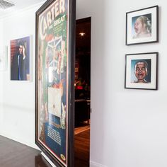 an open door leading into a room with posters on the wall and pictures above it