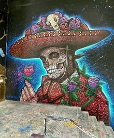 a painting of a skeleton wearing a sombrero and holding a rose in his hand