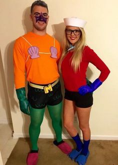 a man and woman in costumes standing next to each other, both dressed as the same person