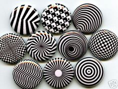 some black and white buttons are arranged in the shape of an opticalally spiral pattern