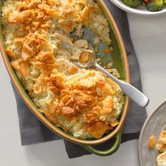 a casserole dish with broccoli, carrots and cauliflower