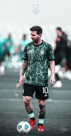 a man standing next to a soccer ball on top of a field with people in the background