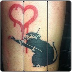 a tattoo with a rat holding a heart on it