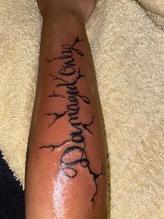 a person with a tattoo on their arm that says, love and family in cursive writing