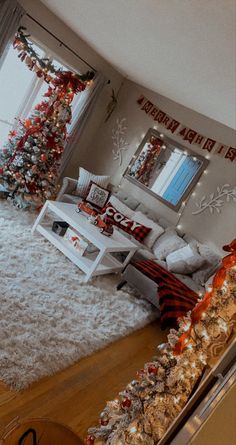 the living room is decorated for christmas with red and silver decorations on the walls, white fur rugs, and large windows