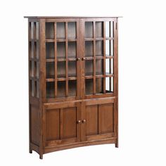 a wooden bookcase with glass doors on the top and bottom shelves, in front of a white background