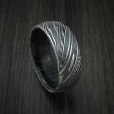 a black and white ring sitting on top of a wooden table