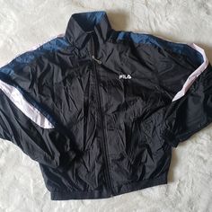 Fila Windbreaker Mens Jacket. Vintage 90s/Y2k Brand New Without Tags (Nwot) This Was All The Rage In The 1990s! Fila Was The Brand!! Men Would Wear Windbreaker Pants And Matching Windbreaker Jackets. This Is Black, White And Dark Teal. The Size Is A Medium. Excellent Condition As It Has Never Been Worn! 80s/2000s/Y2k Vintage Black Long Sleeve Outerwear, Black Vintage Long Sleeve Outerwear, Retro Black Outerwear With Pockets, Retro Black Hooded Windbreaker, Retro Black Sports Outerwear, Retro Black Hooded Track Jacket, Vintage Black Windbreaker For Sports, Vintage Black Track Jacket With Pockets, Black Vintage Track Jacket With Pockets