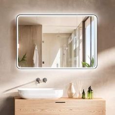 a bathroom sink sitting under a large mirror next to a wooden cabinet with bottles on it