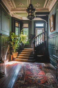 a staircase leading up to the second floor in an old - fashioned house with green walls and wood floors