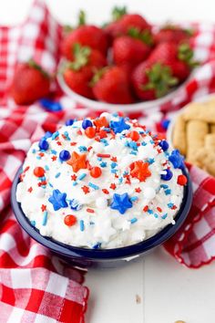 red, white and blue cheesecake in a bowl with strawberries on the side