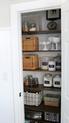 an open pantry with baskets and other items