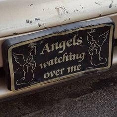 an angel's watching over me sticker on the back of a silver car