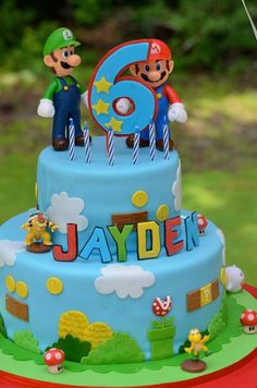 a birthday cake with mario and luigi on top