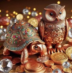 two golden owls sitting on top of coins