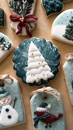 decorated christmas cookies are displayed on a table