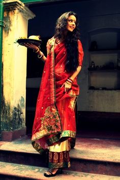 a woman standing on steps holding a plate