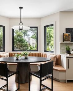 a dining room table surrounded by black chairs