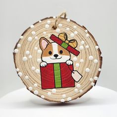 a wooden ornament with a dog wearing a christmas present