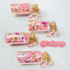 three glass jars filled with pink and gold confetti