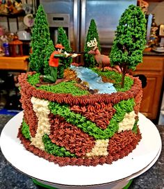 a large cake decorated with trees and animals