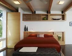 a bed sitting in a bedroom next to a window with wooden beams on the ceiling